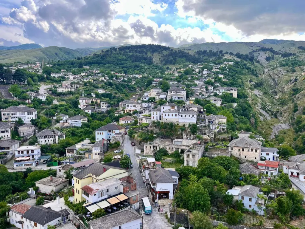 Panoramic view of Gjirokastër’s hillside stone houses – a cultural gem easily reached by car rental from Ksamil
