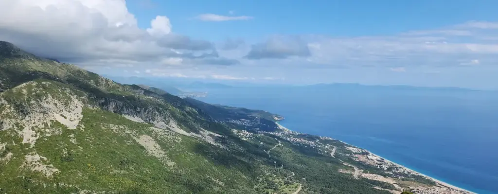 Panoramic coastal view from Llogara Pass along the SH8 highway – a breathtaking route ideal for Ksamil car rental road trips on the Albanian Riviera.
