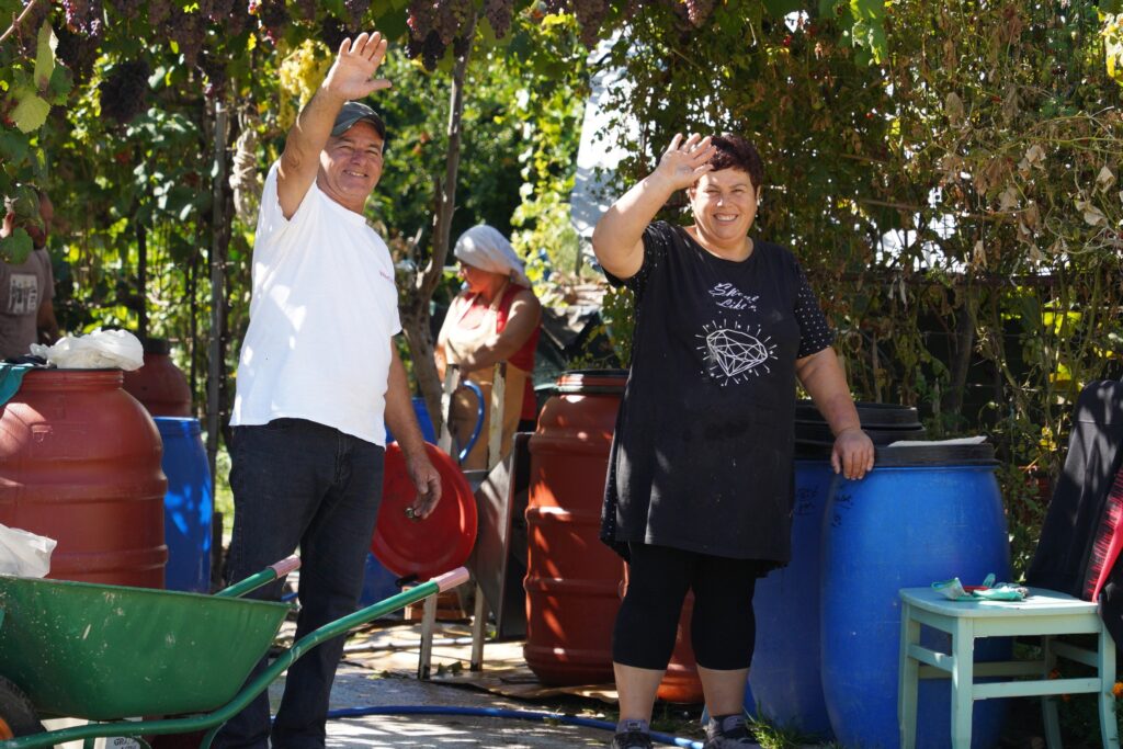 Local farmers welcoming visitors at Tamo’s Farm during grape harvest season in South Albania