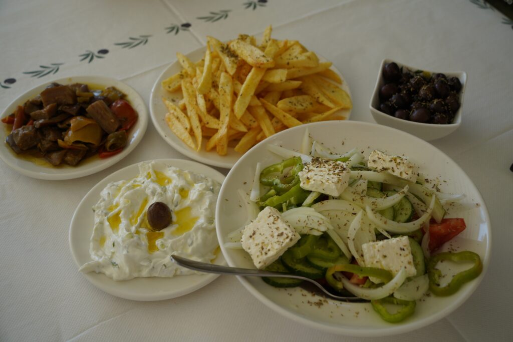 Traditional Albanian appetizers and fresh salad served at Tamo’s Farm restaurant in South Albania