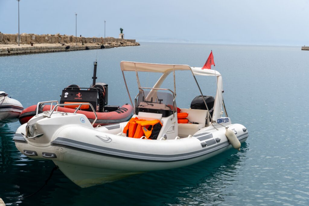 A white inflatable speedboat with life jackets, docked at the port of Vlora before a Vlora boat trip.

