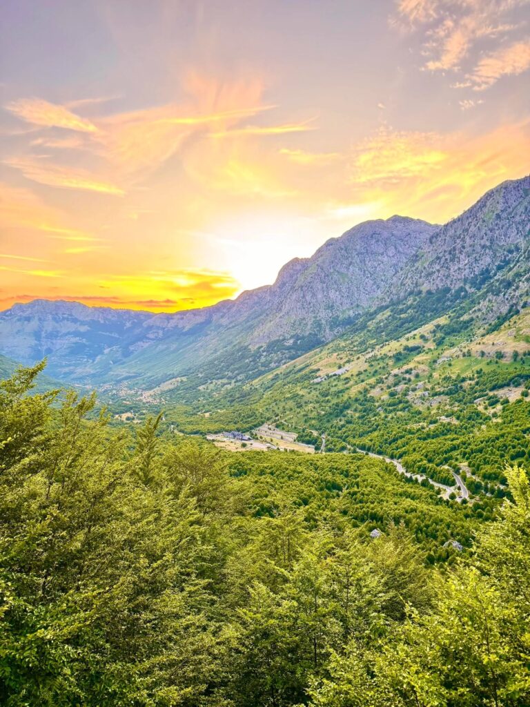 Mountain view from Theth village towards the Albanian Alps, highlighting the scenic backdrop of the SH21 route.