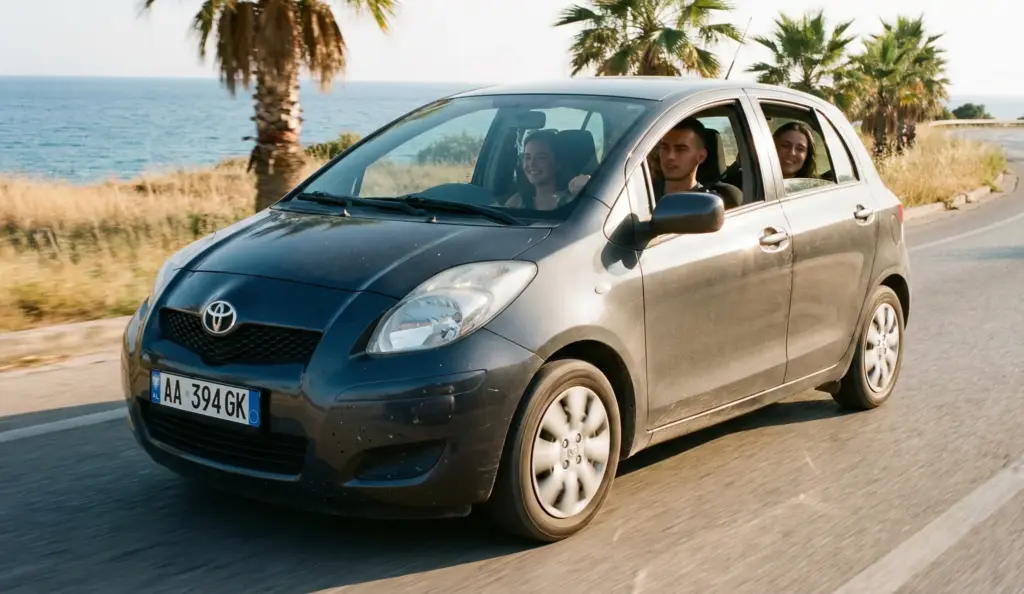 Car Rental in Albania Under 25: How to Avoid Young Driver Fees & Hidden Surcharges 1 Young drivers on an Albanian coastal road in a rental car – car rental in Albania under 25