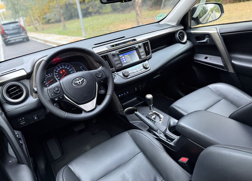 Best SUV Rentals in Albania: Duster vs Tucson vs RAV4 for Mountains & Beaches 1 Toyota RAV4 hire Albania interior – Premium automatic SUV rental in Tirana with leather seats and modern dashboard.